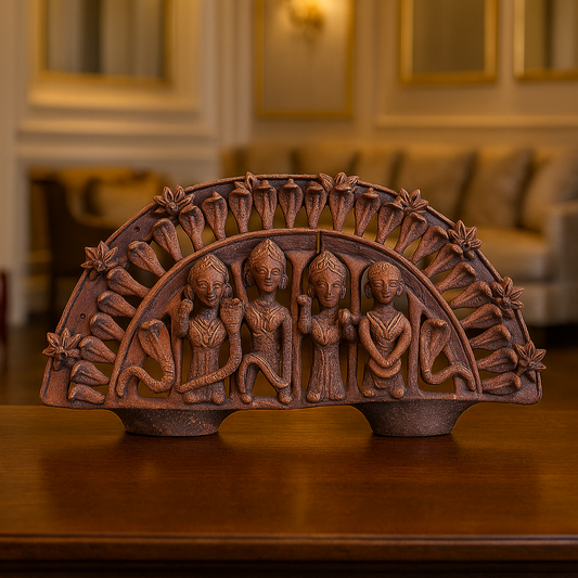 Front view of a handcrafted Panchmura terracotta Manasa Chali sculpture with rows of cobra hoods and small devotional figurines below the goddess Lifestyle Image