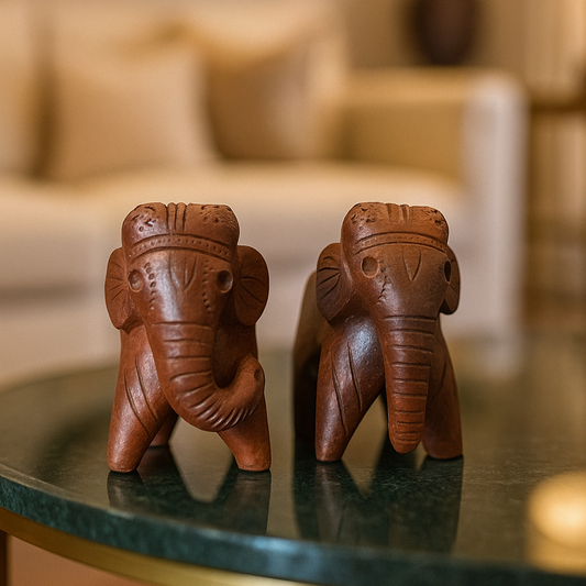 Front view of a handcrafted terracotta elephant figurines in warm natural clay, made in Panchmura, Bankura, decorative pair for home décor lifestyle image