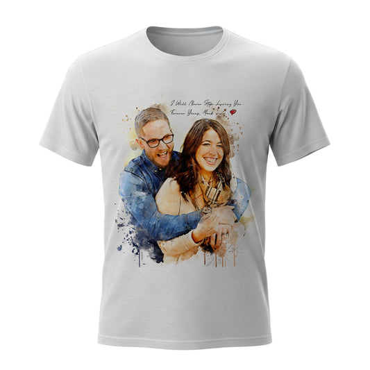 A white t-shirt featuring a custom realistic watercolor portrait of a smiling couple hugging. The design includes personalized handwritten text reading "I Will Never Stop Loving You," making it a unique romantic gift idea for anniversaries or Valentine's Day.