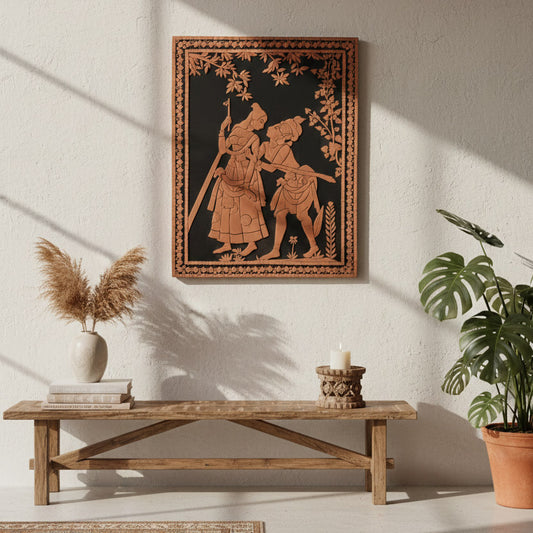 Indian folk wall art depicting Radha and Krishna in terracotta tones, styled above a wooden bench with plants in a sunlit interior.