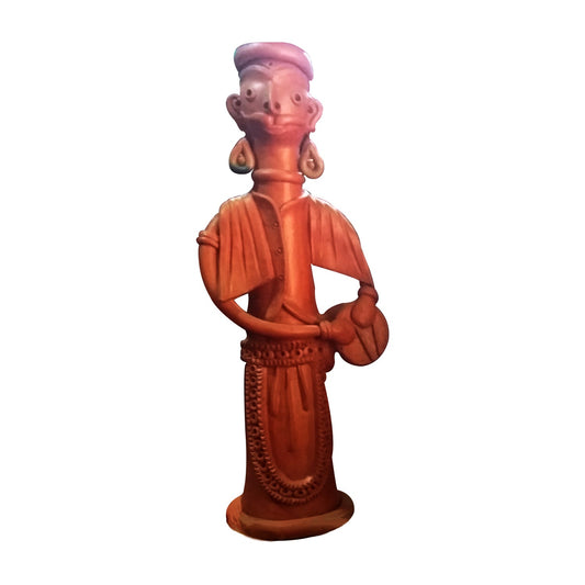 A front view of a single handcrafted terracotta figurine depicting a traditional musician playing a drum (dhol). The clay doll features detailed engravings on the attire and jewelry, representing authentic Indian folk art with a natural reddish-brown earthenware finish, isolated against a white background.