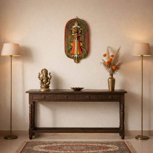 Indian terracotta goddess durga wall hanging styled above a wooden console table, ethnic folk art wall decor paired with brass Ganesha statue and warm minimalist home interior.
