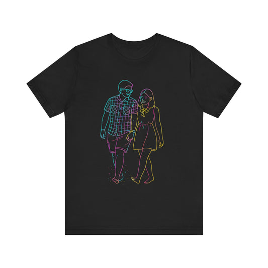 Black t-shirt with colorful graphic of a man and woman walking on a white background