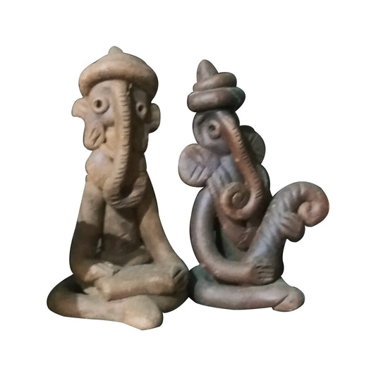 Front view of handmade terracotta Ganesha idols holding musical instruments in warm reddish-brown clay, Panchmura folk art for home décor
