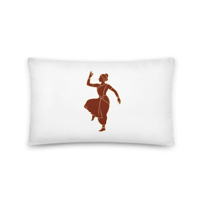 A smiling woman holding a large, white square decorative pillow featuring a terracotta-colored silhouette of a classical Indian dancer in a traditional pose.