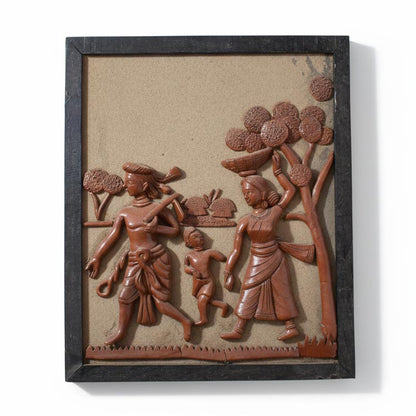 Ethnic terracotta wall decor featuring a tribal family procession, artisan clay sculpture inspired by Indian rural culture and folk traditions.