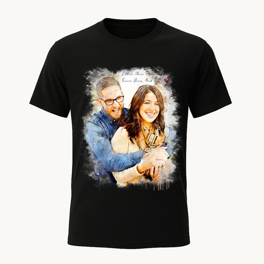 A black t-shirt displaying a vibrant custom watercolor portrait of a happy couple. The dark background contrasts with the colorful personalized artwork and the text "I Will Never Stop Loving You," creating a striking romantic gift.