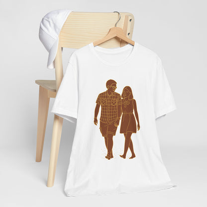 Personalized couple graphic tee folded flat, displaying custom photo-to-sketch design in cyan and magenta.
