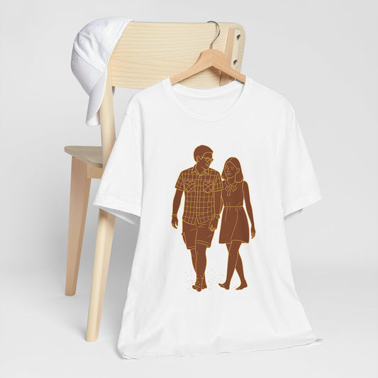 Personalized couple graphic tee folded flat, displaying custom photo-to-sketch design in cyan and magenta.
