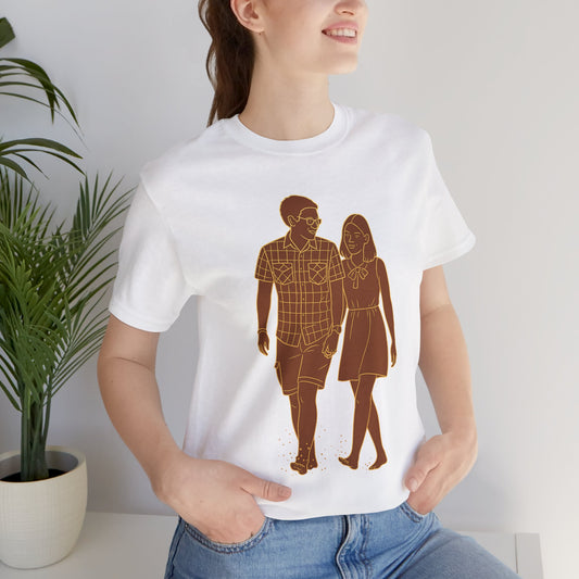 Flat lay of white t-shirt featuring custom sepia line art of a couple walking, minimalist graphic tee product photography.