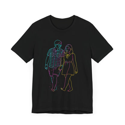 A top-down flat lay product shot of a black T-shirt featuring a custom neon gradient line art illustration of a couple walking, isolated against a white background.