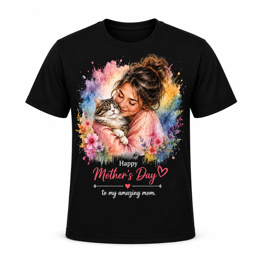 A custom black unisex t-shirt featuring a vibrant watercolor portrait of a smiling cat mom hugging her tabby cat, surrounded by pastel spring flowers and "Happy Mother's Day" text.