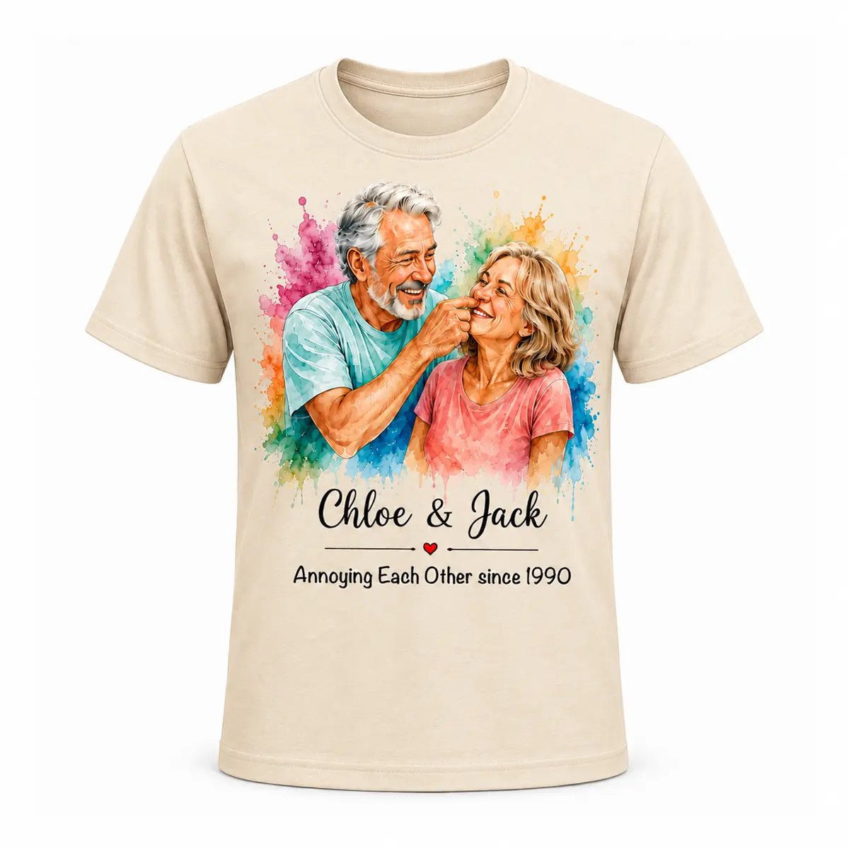A beige unisex t-shirt featuring a custom watercolor portrait of a smiling older couple surrounded by vibrant paint splatters, with funny anniversary text below. Free shipping by Incotta.