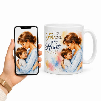 A custom watercolor portrait mug showing a mother and son embracing with "Forever in My Heart" text, beside a smartphone. Free shipping by Incotta.