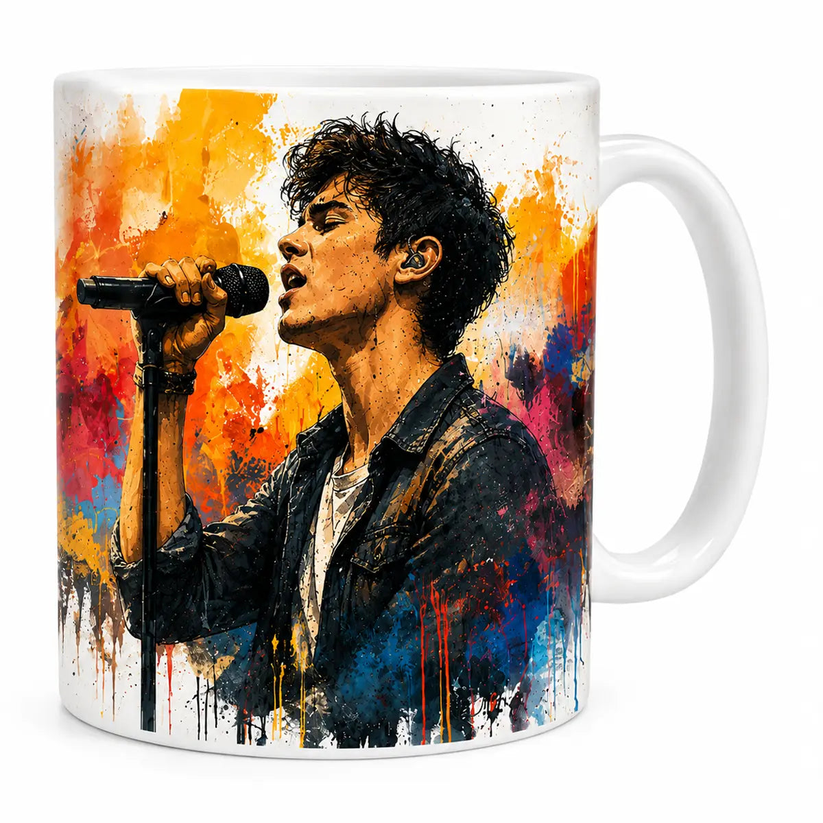 A glossy white ceramic coffee mug with a custom watercolor portrait of a male singer holding a microphone surrounded by vibrant orange, pink, and blue paint splatters. Free shipping by Incotta.