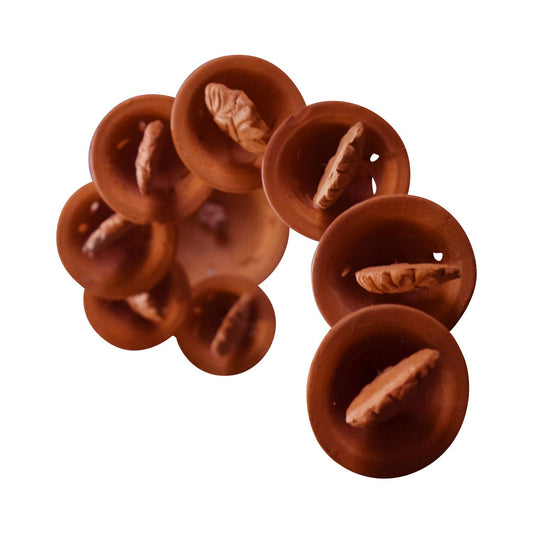 A clear bottom-up view of a handcrafted terracotta wind chime featuring a cluster of 9 small clay bells. The image isolates the underside of the bells on a white background, highlighting the textured leaf-shaped clappers hanging within each bell, characteristic of traditional Panchmura craftsmanship.
