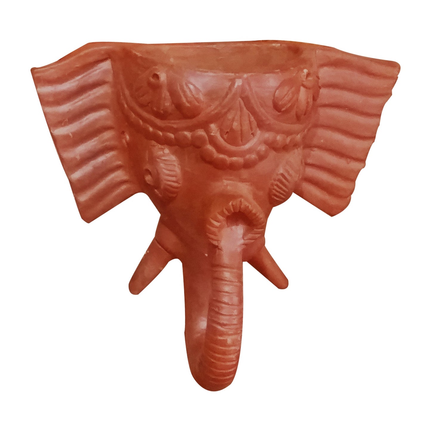 A front view of a handcrafted terracotta wall hanging depicting the head of Lord Ganesha. This traditional clay sculpture features an elephant face with intricate engraved detailing on the forehead, ears, and trunk, presented in a natural reddish-brown earthenware finish against a white background.