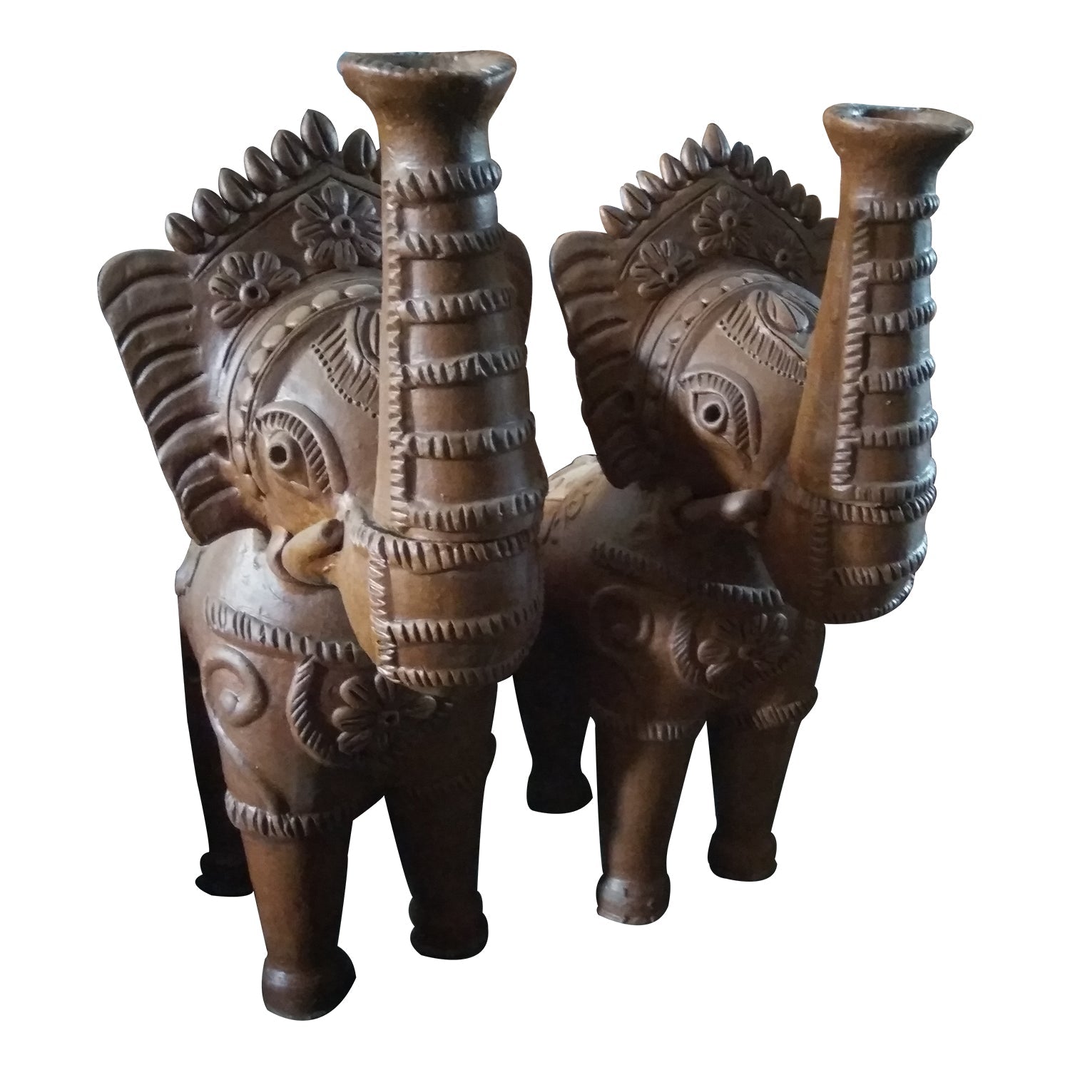 A front view of a pair of handcrafted terracotta elephant figurines. These traditional clay statues feature raised trunks—a symbol of good fortune—and intricate engraved detailing on the head and body, showcasing rustic Indian folk art craftsmanship in a natural brown finish.