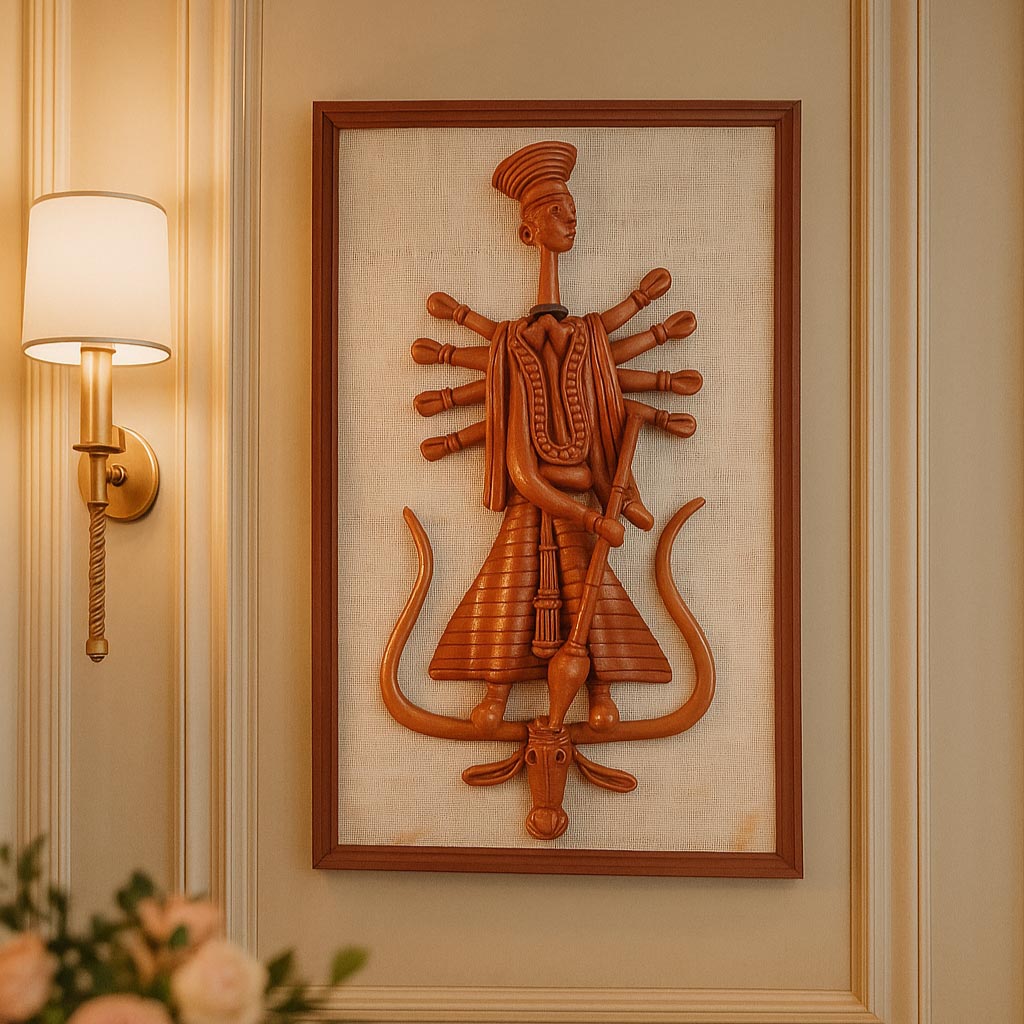 Front view of a framed wall hanging featuring a stylized terracotta sculpture of Goddess Durga with multiple arms, crafted in the traditional Panchmura style. The reddish-brown clay figure is mounted on a textured beige fabric backing within a wooden frame.