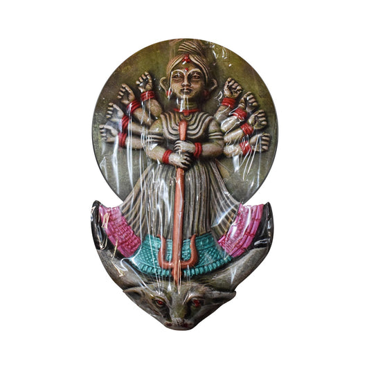 A front view of a handcrafted terracotta wall hanging depicting Goddess Durga. This multicolor clay sculpture features traditional folk art detailing with the ten-armed goddess holding a trident (Trishul) and standing atop her lion vahana, finished with vibrant hand-painted accents in green, red, and pink against a white background.
