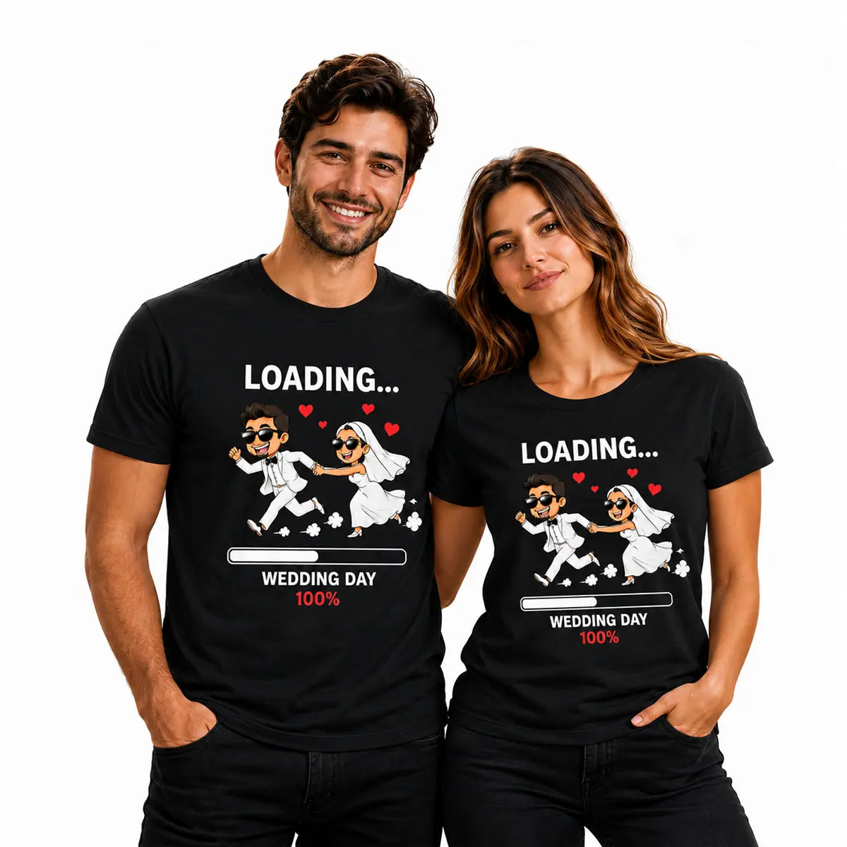 Couple wearing matching black T-shirts featuring a playful wedding loading design with a running bride and groom, hearts, and “Wedding Day 100%” graphic.