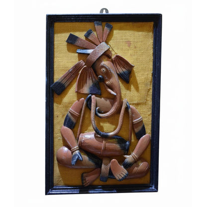 Handcrafted Indian tribal wall art depicting Lord Ganesha in folk style, ethnic wall hanging sculpture framed in wood.