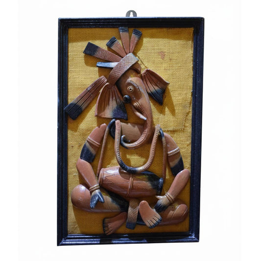 Handcrafted Indian tribal wall art depicting Lord Ganesha in folk style, ethnic wall hanging sculpture framed in wood.