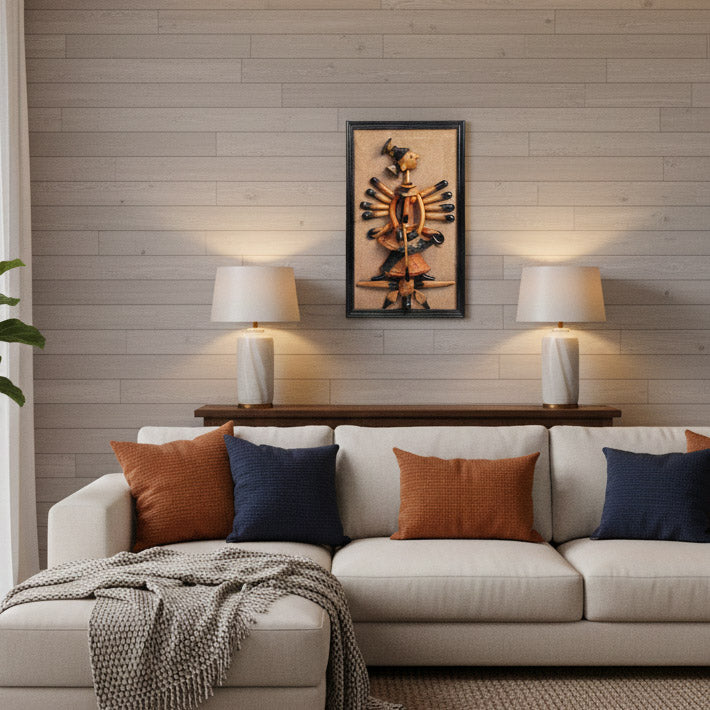 Indian handicraft tribal wall art mounted above a sofa, styled with table lamps and contemporary interior design.