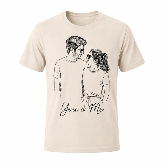 A beige natural color unisex t-shirt featuring a custom minimalist line art portrait of a smiling couple. Perfect for personalized anniversary gifts. Free shipping by Incotta.