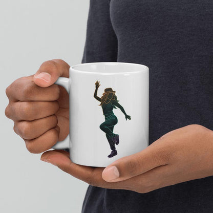 A lifestyle close-up showing a person's hands holding the white ceramic mug featuring the dancing woman line art design. This angle demonstrates the mug's scale and grip comfort, with the neon gradient illustration clearly visible against the white surface.