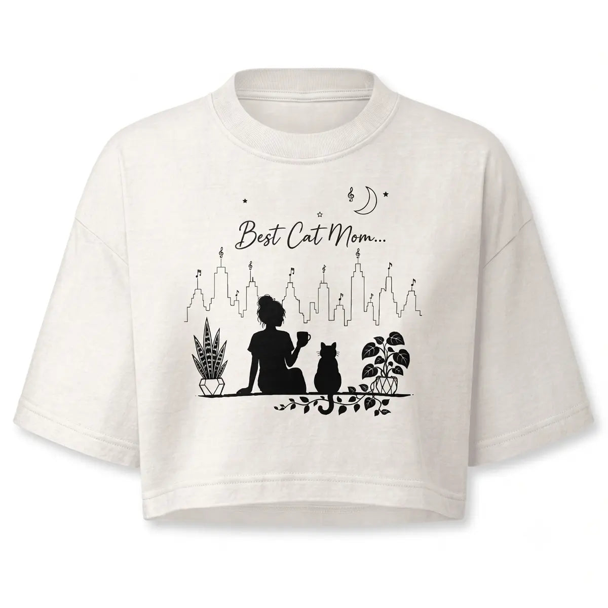 Stay cozy with this personalized minimalist best cat mom crop top in vintage white. Features a black line-art silhouette of a girl holding a coffee mug alongside a cat, potted plants, and a city skyline.