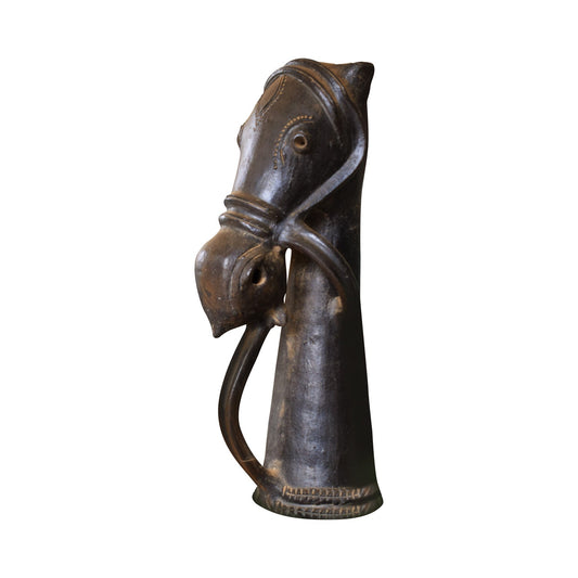 A studio view of a handcrafted black terracotta horse sculpture featuring a stylized, elongated neck and traditional bridle detailing. This unique piece of Indian folk art showcases a dark, burnished clay finish with intricate engravings, isolated against a white background.