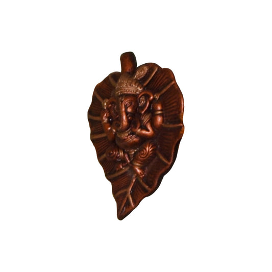 An angled side view of a handcrafted terracotta wall hanging depicting Lord Ganesha seated on a leaf motif. This perspective emphasizes the raised relief of the deity and the textured veins of the leaf, showcasing the depth of the traditional clay craftsmanship against a white background.
