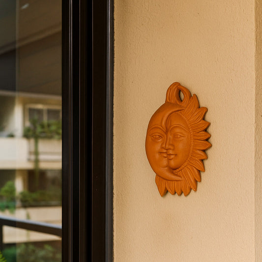 Front view of handcrafted terracotta Surya Chandra wall hanging in warm brown clay from Panchmura, combining Sun and Moon design for home décor lifestyle image