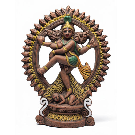 A detailed front view of a handcrafted terracotta statue of Lord Nataraja (Shiva) performing the cosmic Tandava dance. The sculpture is framed by an intricate ring of flames (Prabha Mandala) and features traditional earthen clay tones with hand-painted accents in green, yellow, and white. The deity is depicted with four arms, balancing on the dwarf demon Apasmara, symbolizing the triumph over ignorance.