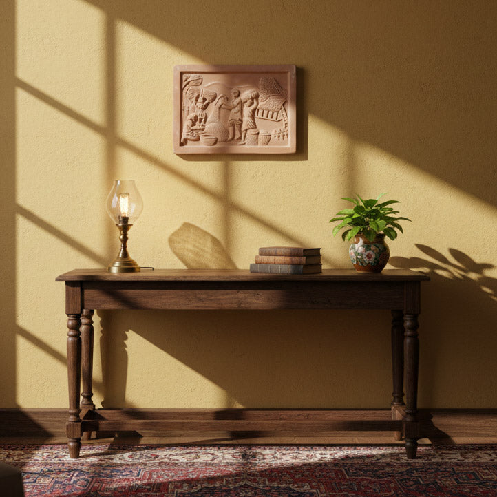 Handcrafted terracotta relief wall panel styled in a minimalist interior with wooden console table, table lamp, books, and indoor plant, showcasing ethnic Indian home décor.